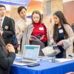 Thumbnail of http://Members%20gather%20at%20an%20event%20table.