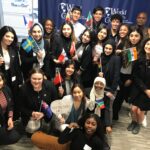 Thumbnail of http://Students%20pose,%20holding%20small%20flags.