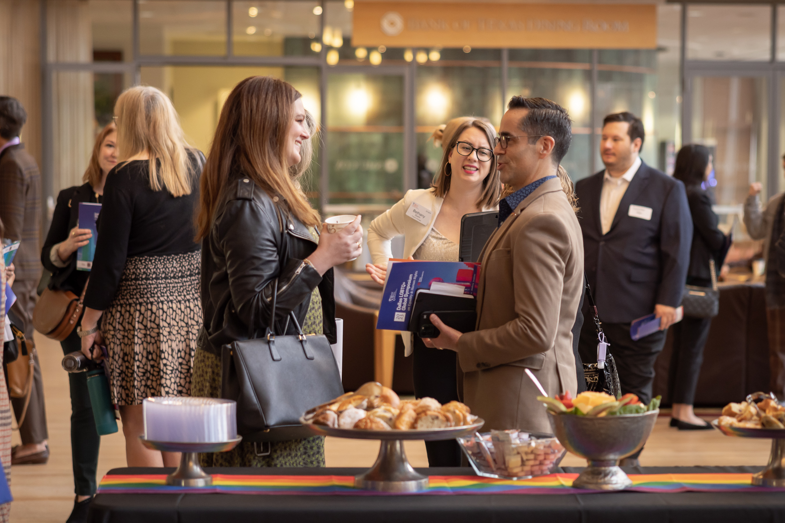Event attendees mingle between panel sessions
